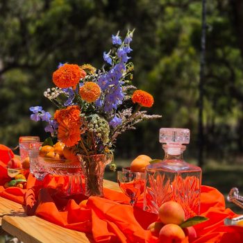 Wedding table décor with flowers and oranges for event styling