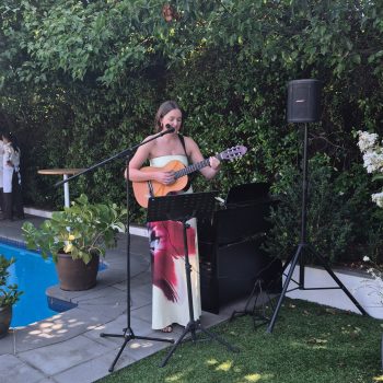 Live guitar performance at a wedding event with audience enjoyment