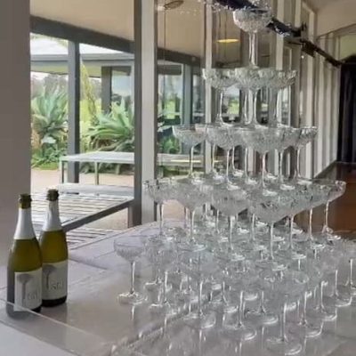 Five-tier luxury champagne tower set up for an elegant wedding celebration.