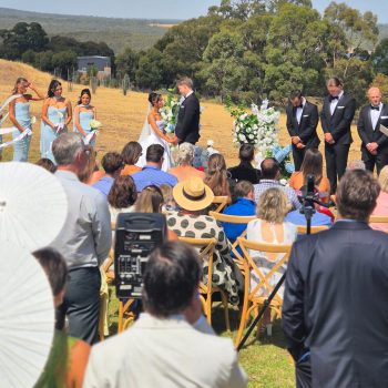 Couple exchanging wedding vows surrounded by guests.